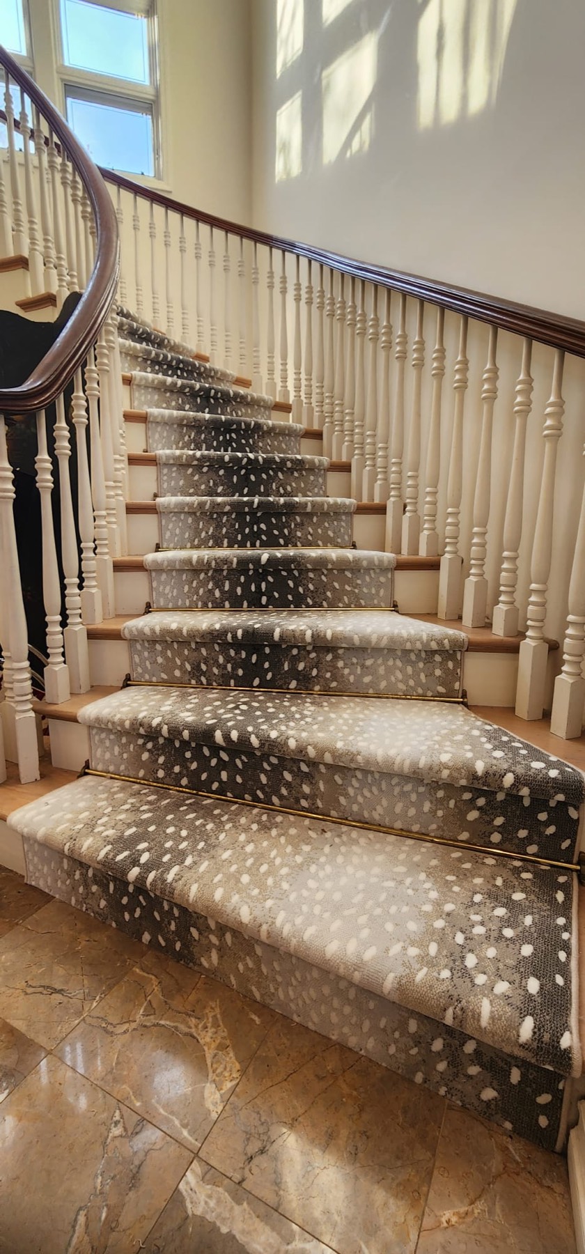 Patterned custom stair runner on a curved staircase in Rockville Centre